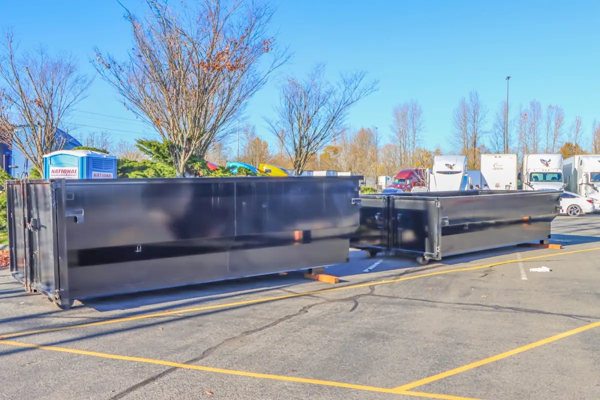 Professional dumpster rental service with roll-off container on residential driveway in Sycamore